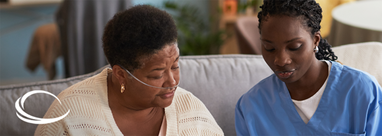 A respiratory therapist speaking with female oxygen patient at their home