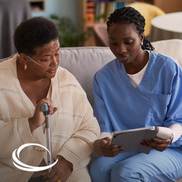A respiratory therapist speaking with female oxygen patient at their home