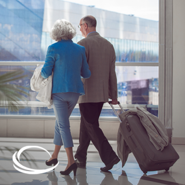 Senior man and woman walking together at the airport