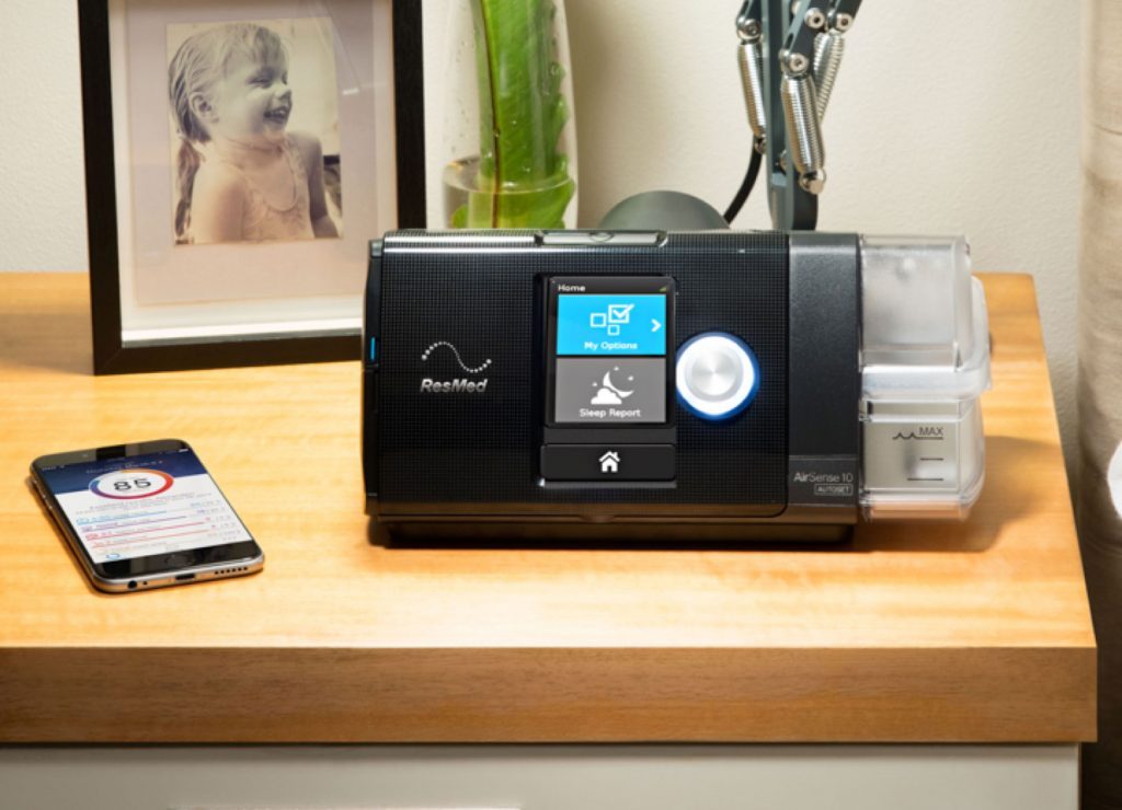 Photo of the AirSense 10 CPAP machine on a table.