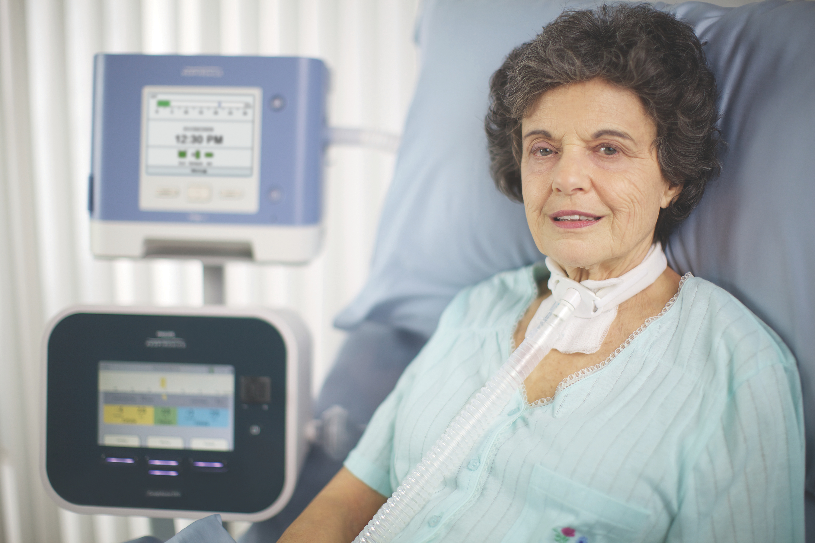 Photo of a woman in the hospital using the CoughAssist T70.