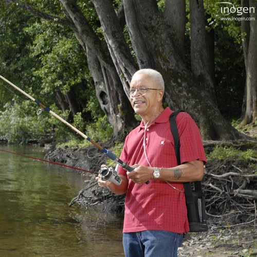 Photo of a person fishing out by the water with the Inogen One G3 with them.