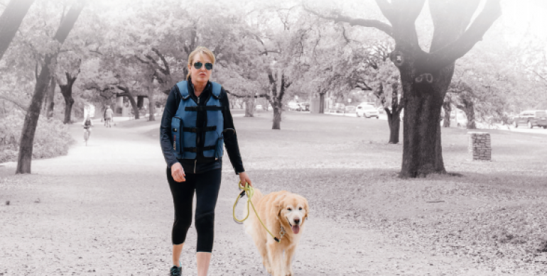 Photo of a person walking outside with the AffloVest on.