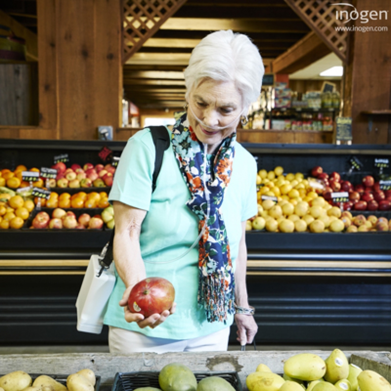 Photo of a woman in the grocery store with the Inogen G4 with her.