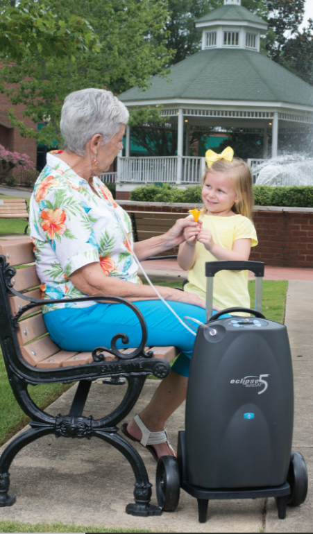Photo of a person with the Sequal Eclipse 5 portable oxygen concentrator.