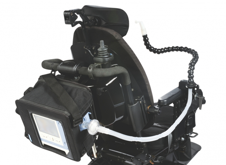 Photo of the Trilogy100 on the back of a wheelchair.