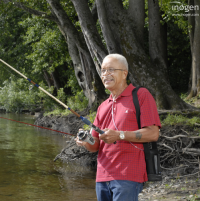 Photo of a person fishing out by the water with the Inogen One G3 with them. thumbnail