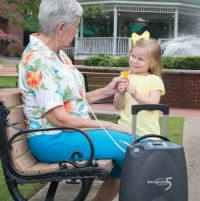 Photo of a person with the Sequal Eclipse 5 portable oxygen concentrator. thumbnail
