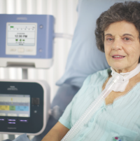 Photo of a woman in the hospital using the CoughAssist T70. thumbnail